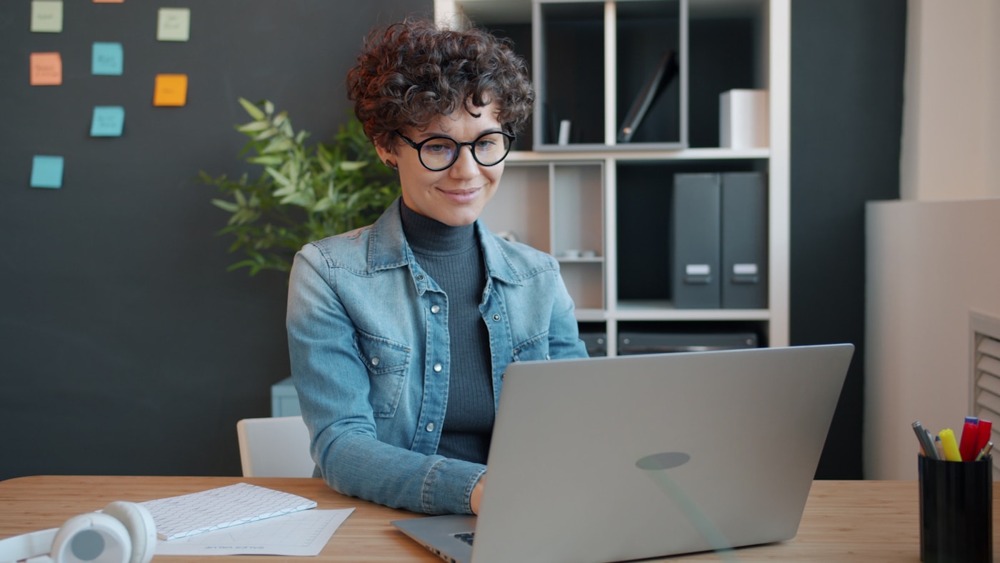 A young professional working on a laptop at a desk